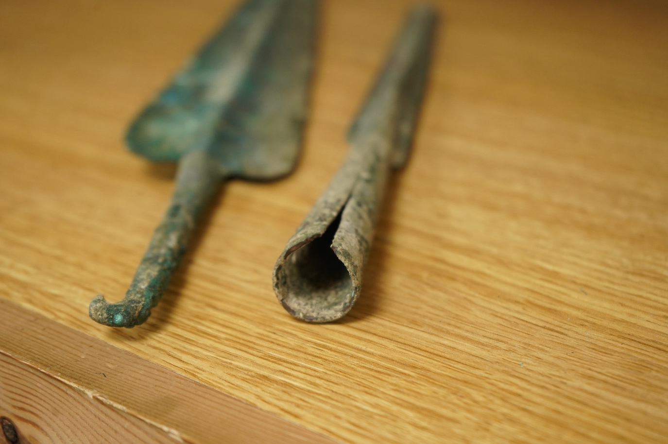 Two assorted Bronze Age spearheads, one of leaf shape with turned over tang, the other short with narrow blade. Condition - poor to fair.